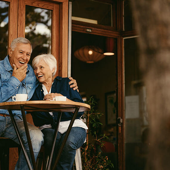 Couple Laughing Together at a Table